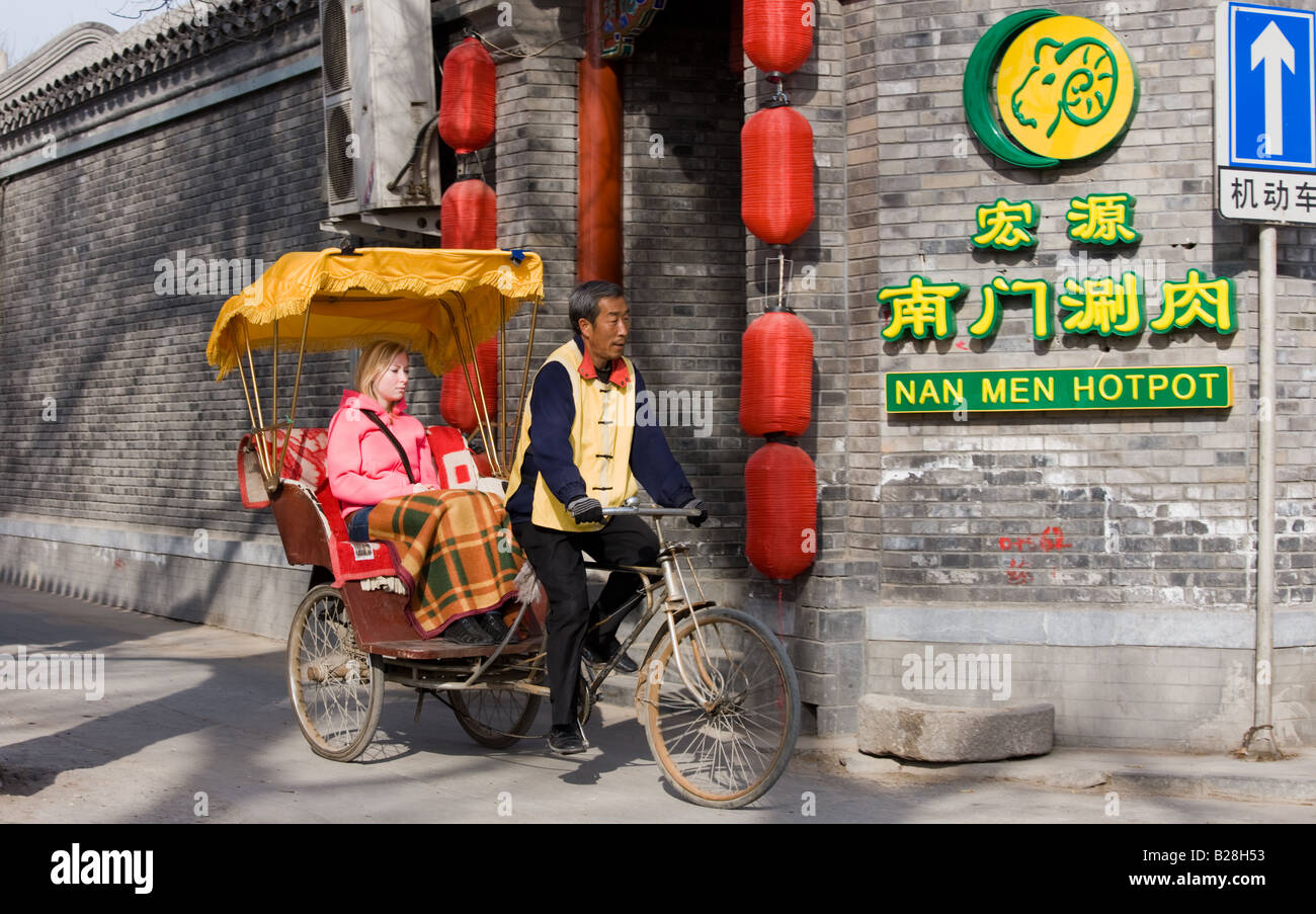 Western tourist in a rickshaw Hutongs area Beijing China Stock Photo