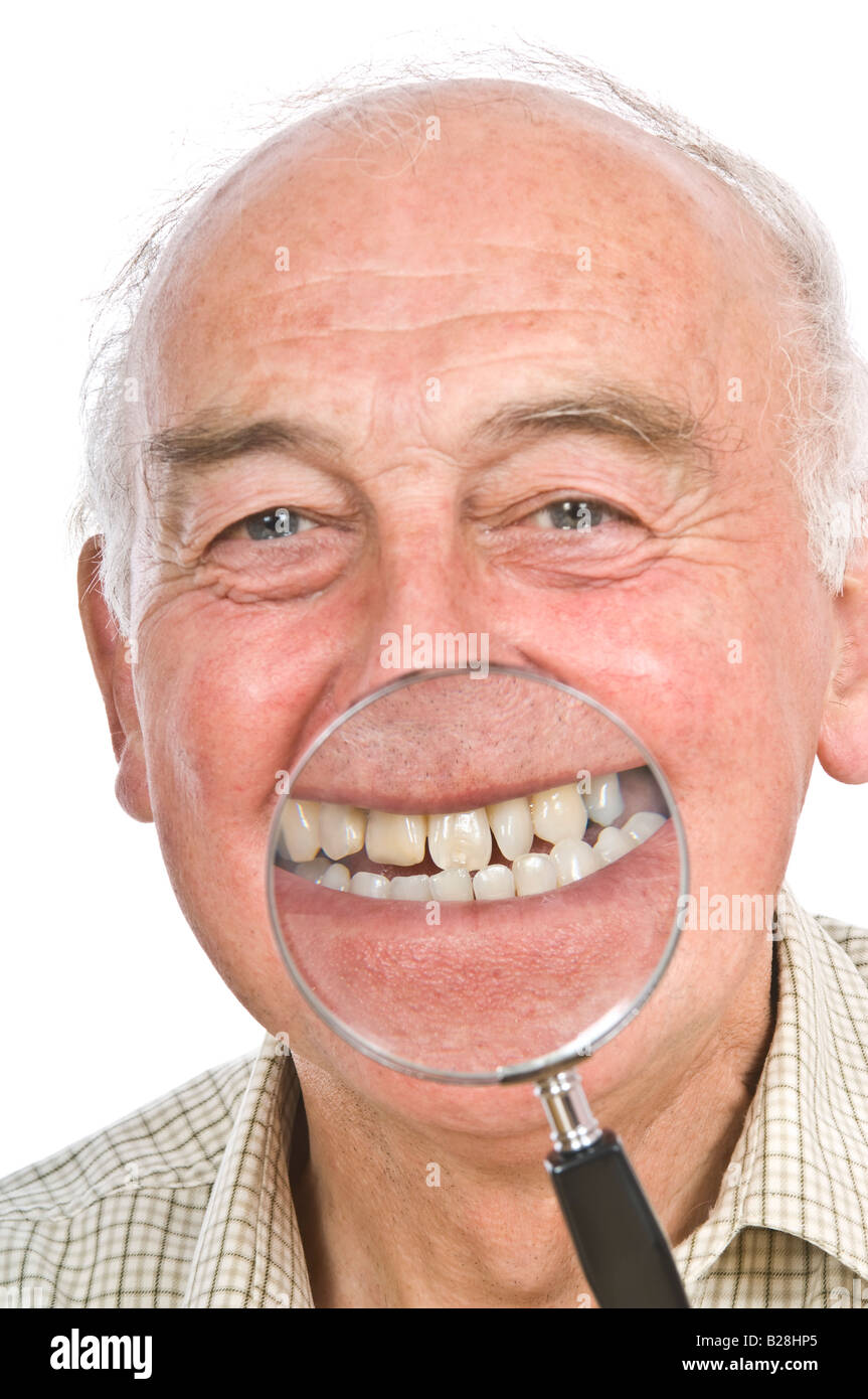 A comical image of an elderly man with a magnifying glass to enlarge his mouth against a pure white (255) background. Stock Photo
