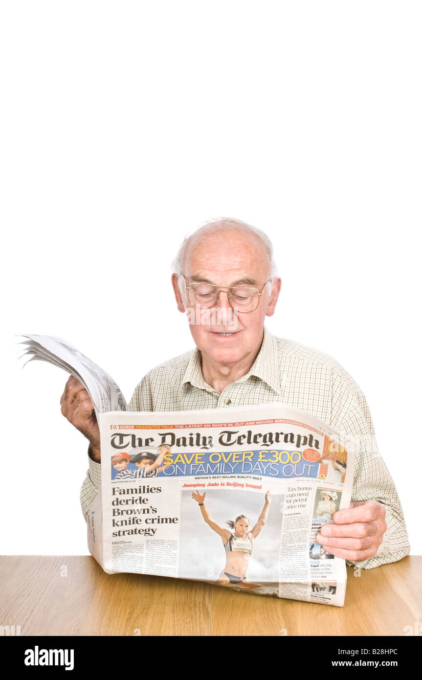An elderly man reading a newspaper sat at a desk against a pure white (255) background. Stock Photo