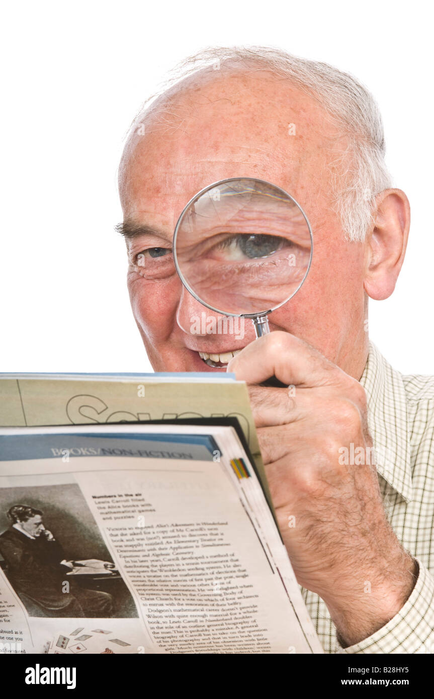 A comical image of an elderly man with a magnifying glass to enlarge one eye against a pure white (255) background. Stock Photo