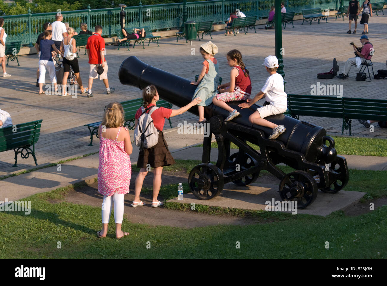 children play on cannons at Dufferin Terrace Quebec City Stock Photo