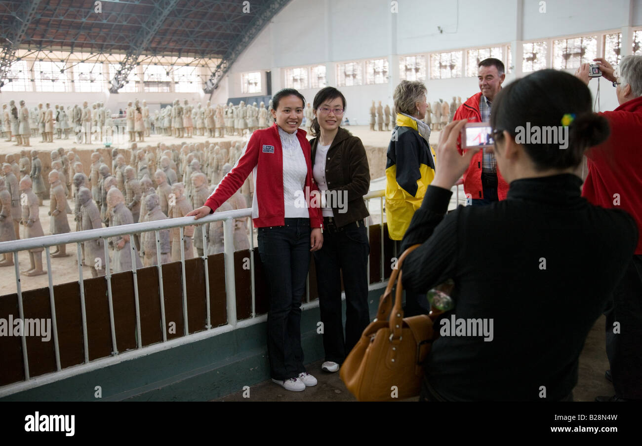 Tourists pose by Pit 1 at Qin Museum exhibition halls of Terracotta Warriors China Stock Photo