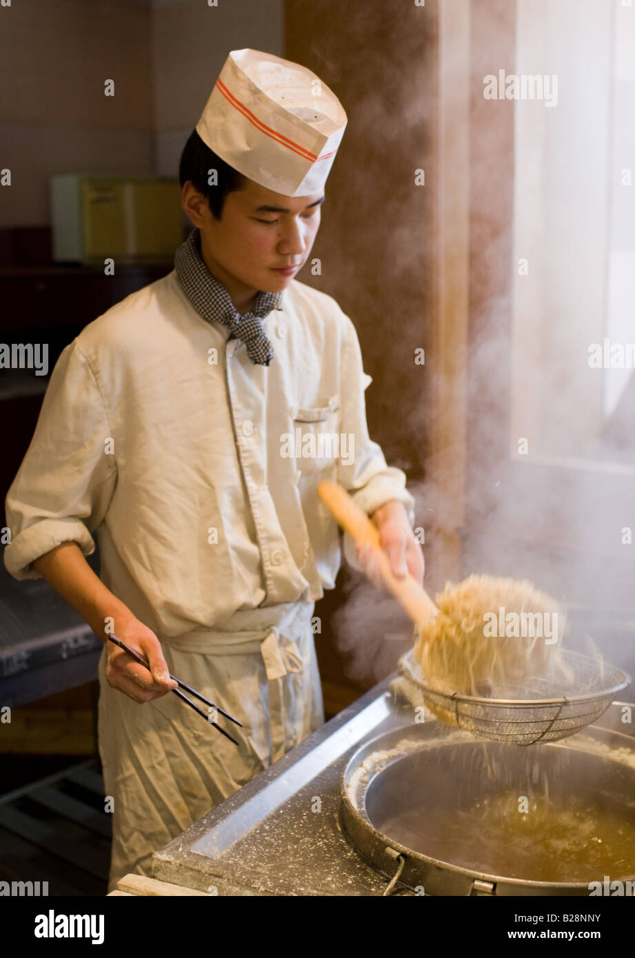 Chef cooking noodles in tourist restaurant Xian China Stock Photo Alamy