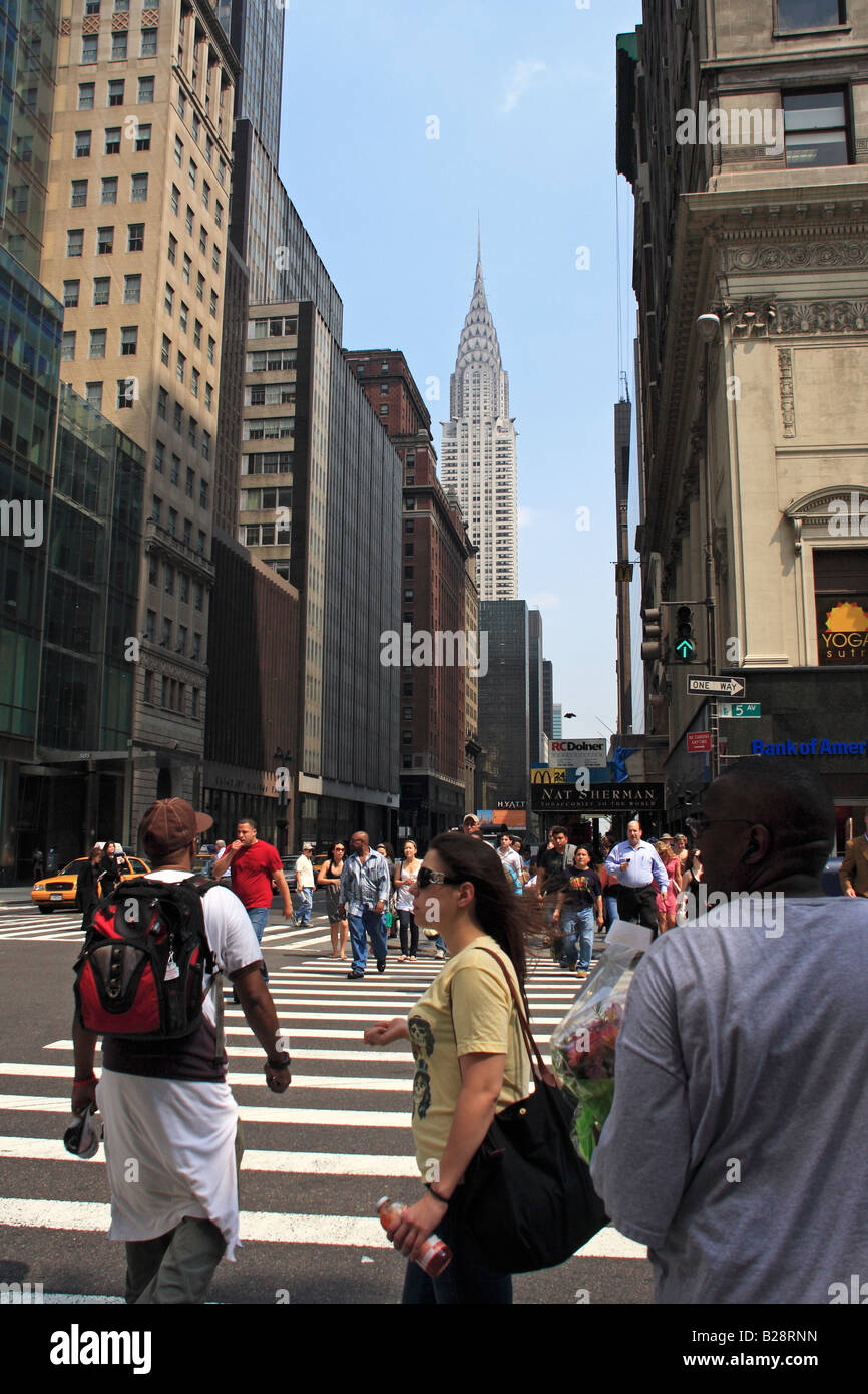 Pedestrians crossing 5th avenue with Chrysler building in the background - New York City, USA Stock Photo