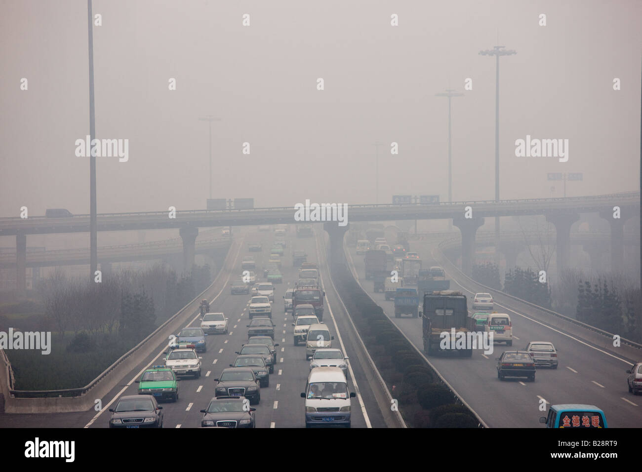 Traffic and pollution on motorway near the financial district of Xian China Stock Photo