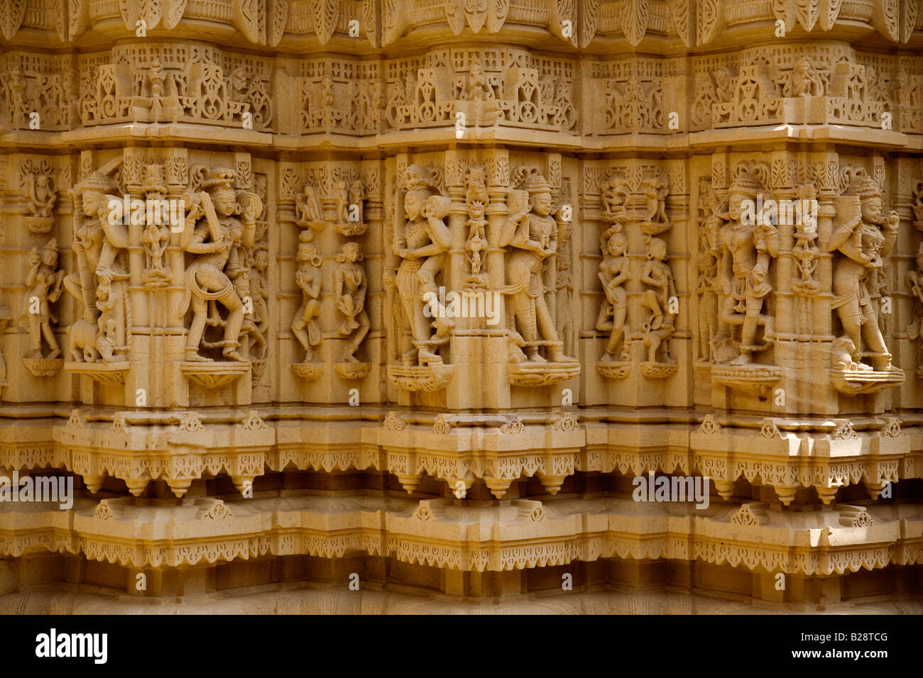 Hand carved GOLDED SANDSTONE DIVAS or Celestial Beings inside a JAIN TEMPLE in the JAISALMER FORT RAJASTHAN INDIA Stock Photo
