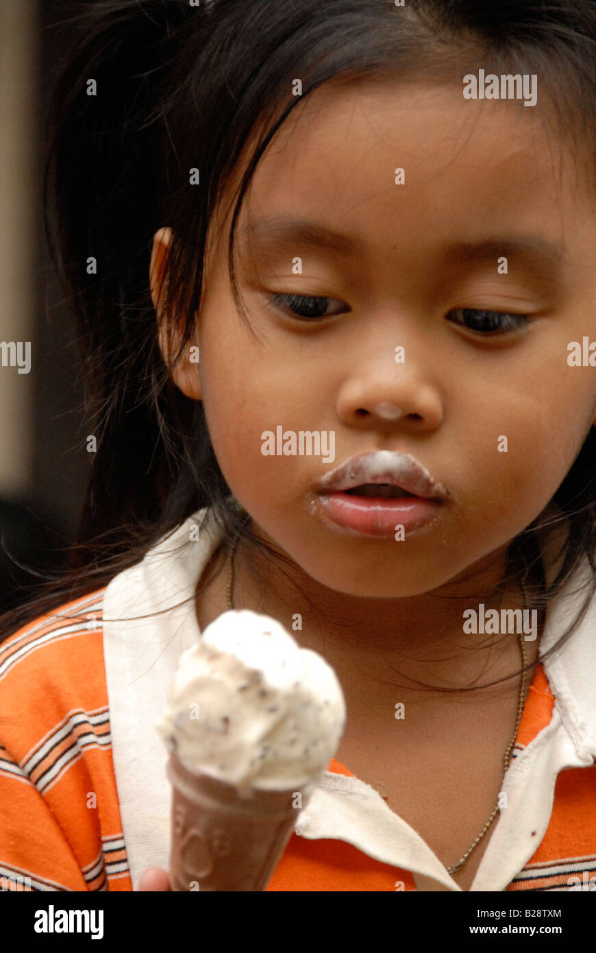 child eating ice cream , Muslim floating village, Koh Panyi Island, Ao Phang Nga , phuket , thailand Stock Photo
