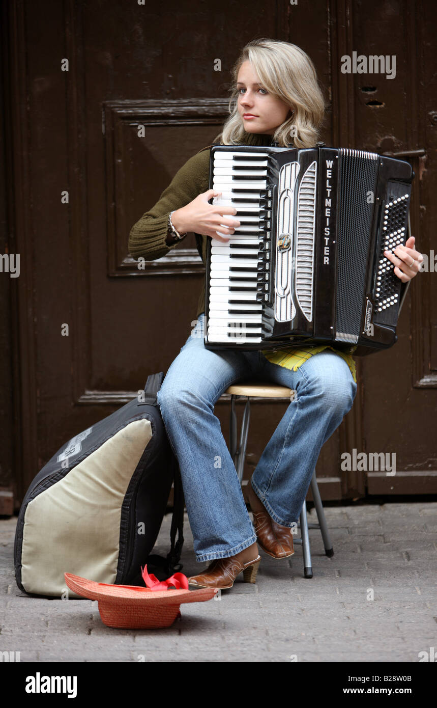 LTU Lithuania Capital Vilnius Female street musician with accordion in the oldtown Stock Photo