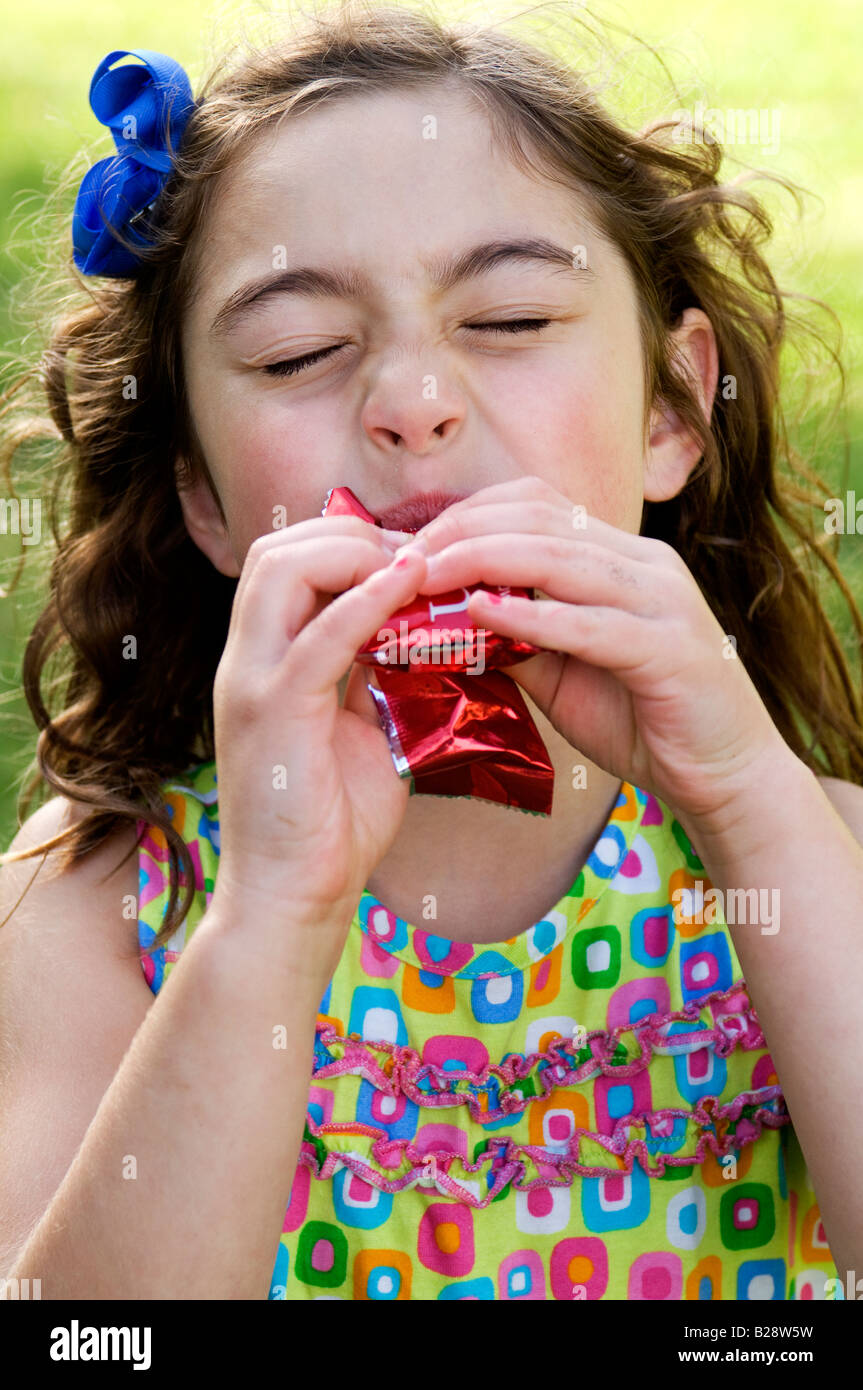 A girl eating an energy bar Stock Photo Alamy