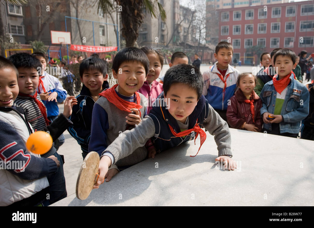 Boys play table tennis in the playground of a primary school in Hong