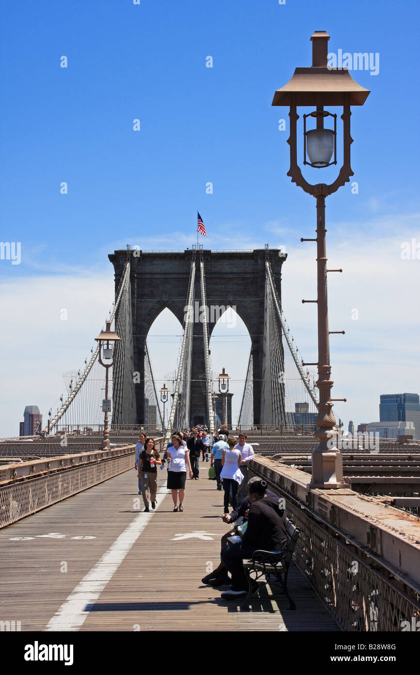People walking on Brooklyn Bridge walkway - New York City, USA Stock Photo