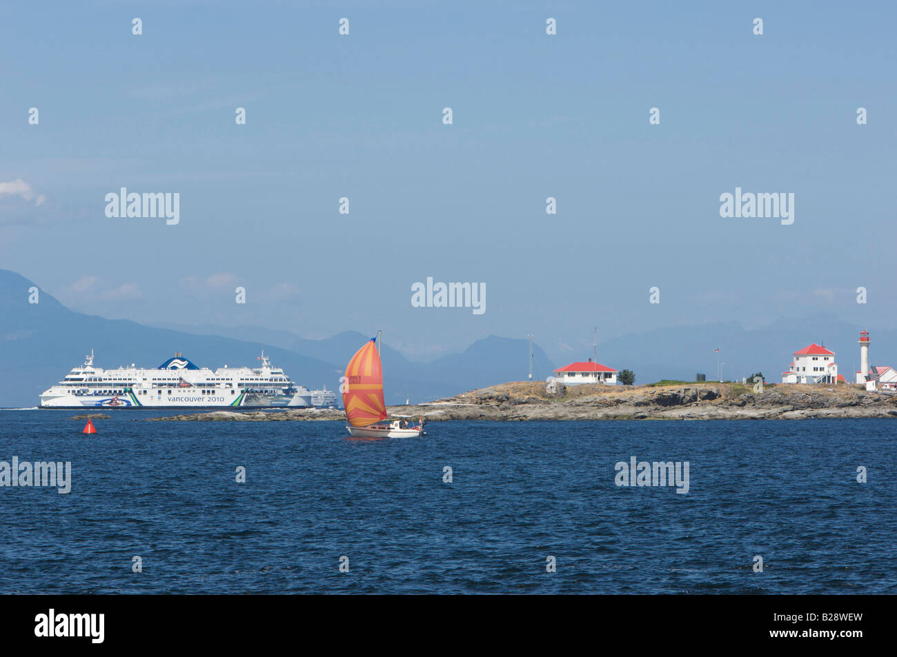 Sailboat with Entrance Island and BC Ferry Stock Photo