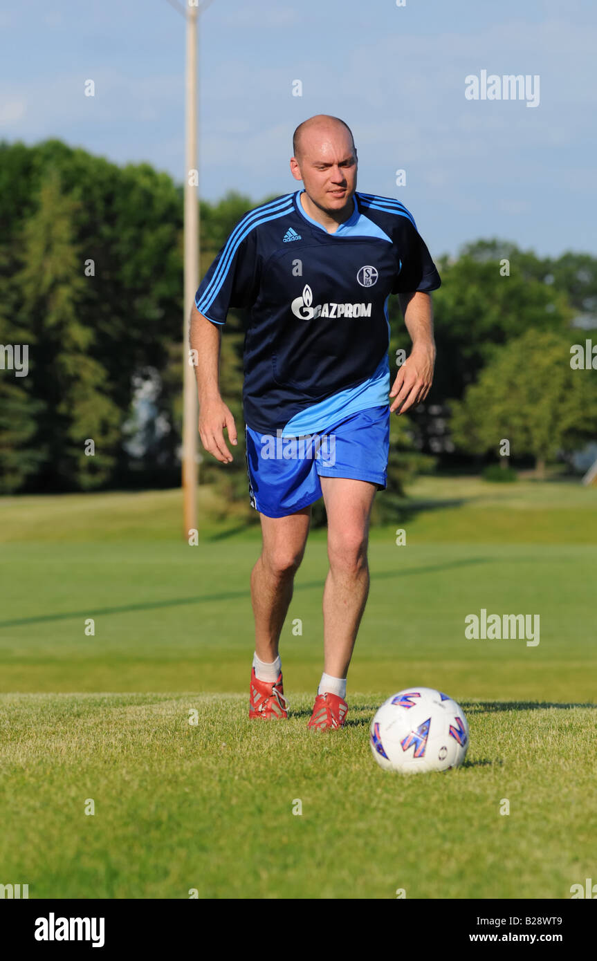 Football player kicking the ball Stock Photo Alamy