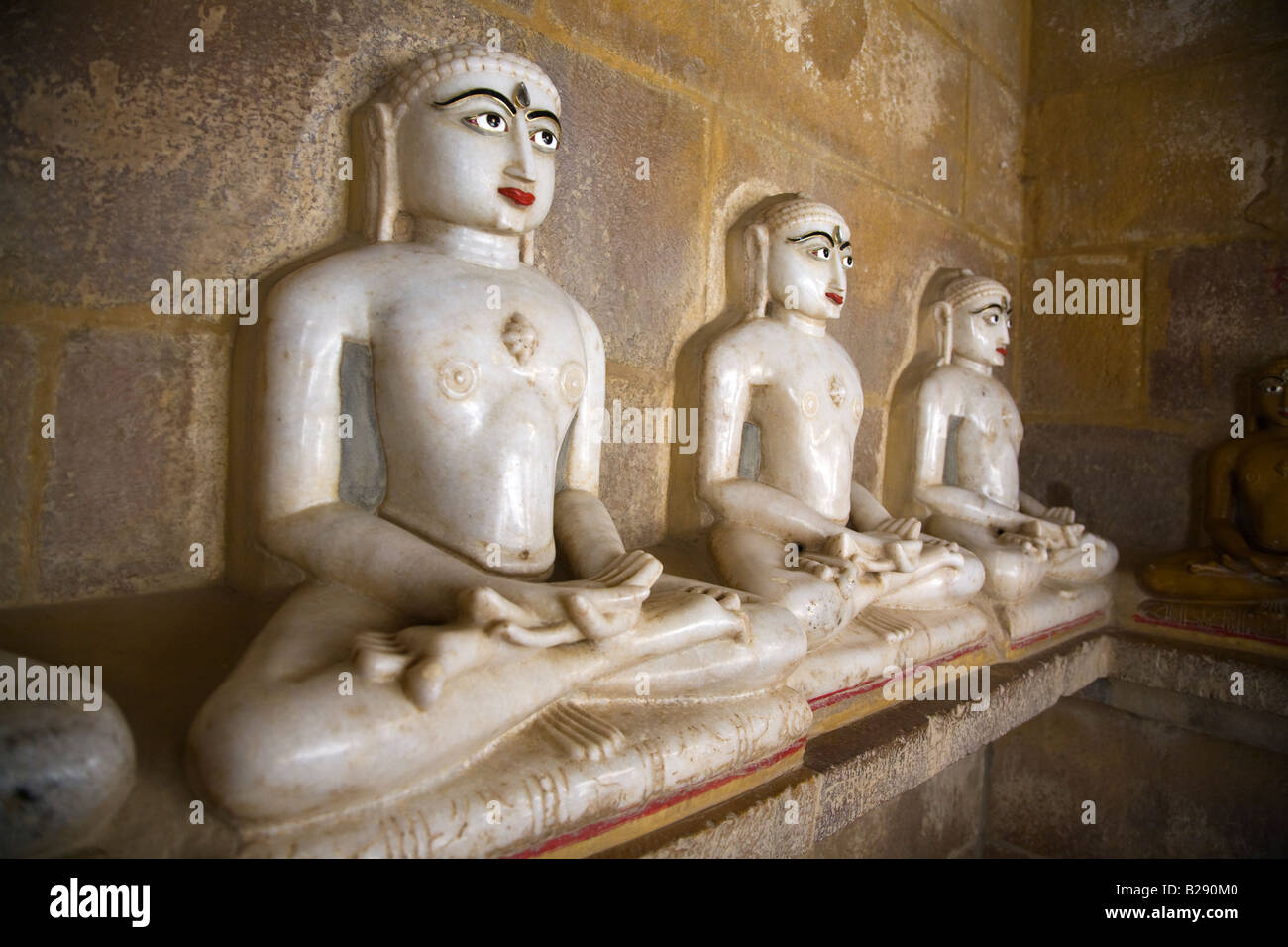 Hand carved WHITE MARBLE statues of MAHAVIRA in a JAIN TEMPLE inside JAISALMER FORT RAJASTHAN INDIA Stock Photo