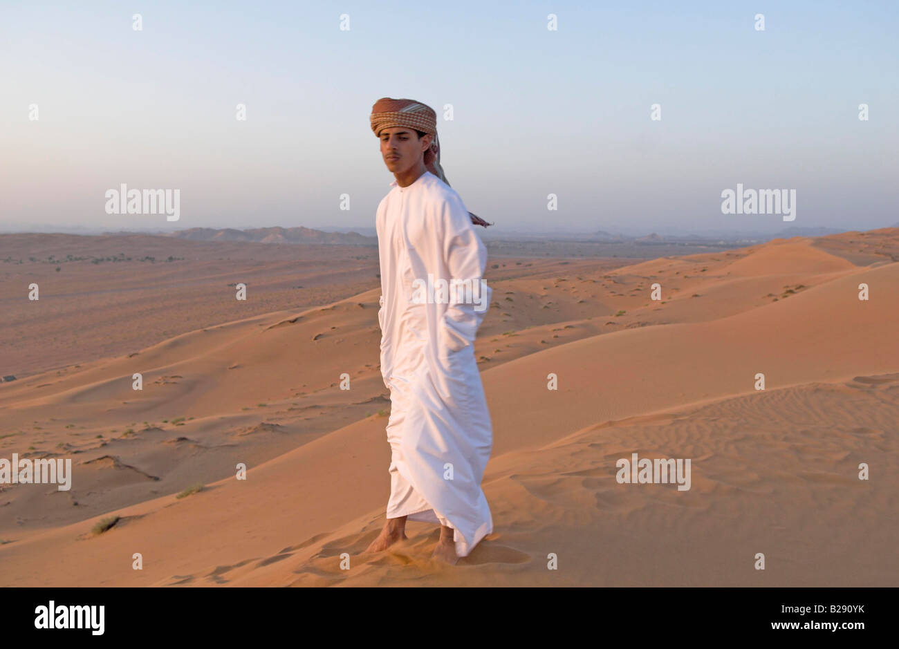 Omani guide wearing traditional dishdasha Wahiba Sands Stock Photo
