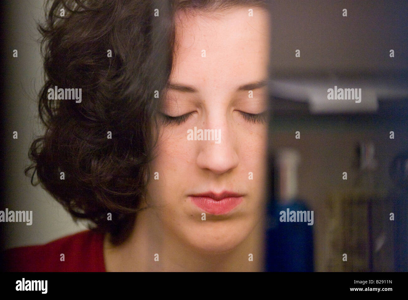 Reflection of a woman in a bathroom sink mirror MR YES Stock Photo - Alamy