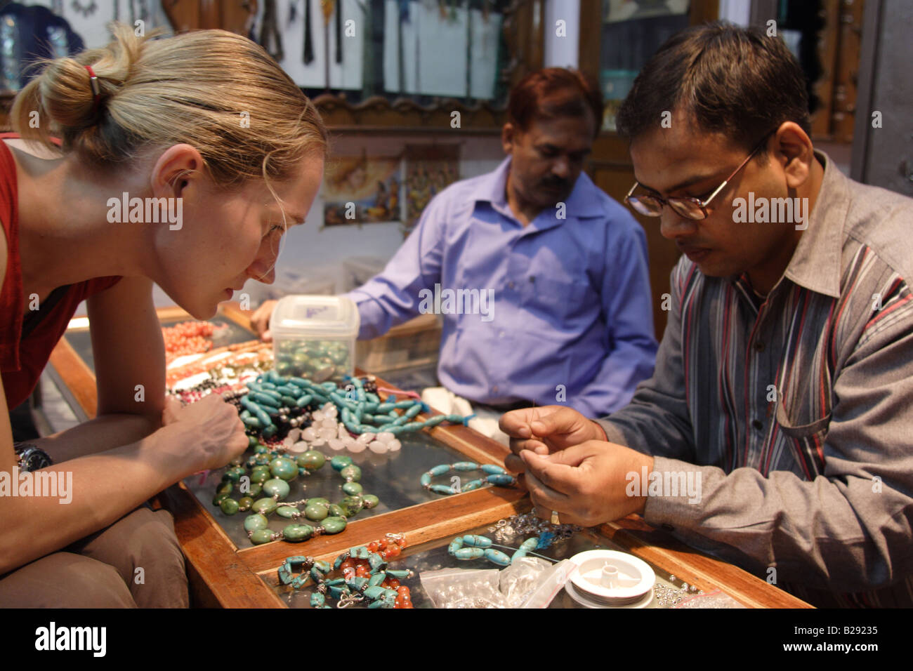 A caucasian woman buys jewelry in a shop in Jaipur, India. Stock Photo