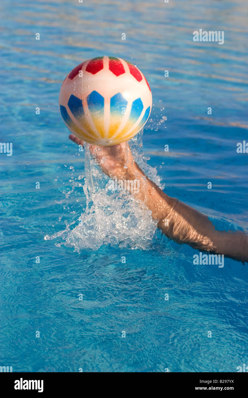 Throwing "Beach Ball" in Swimming Pool Stock Photo Alamy