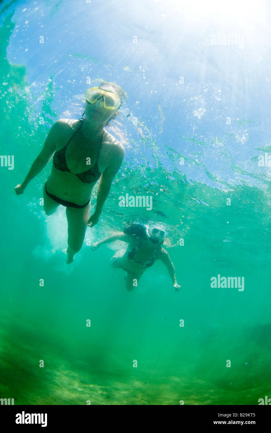 Two young women snorkel Hanalei Bay Princeville Kauai Hawaii Stock