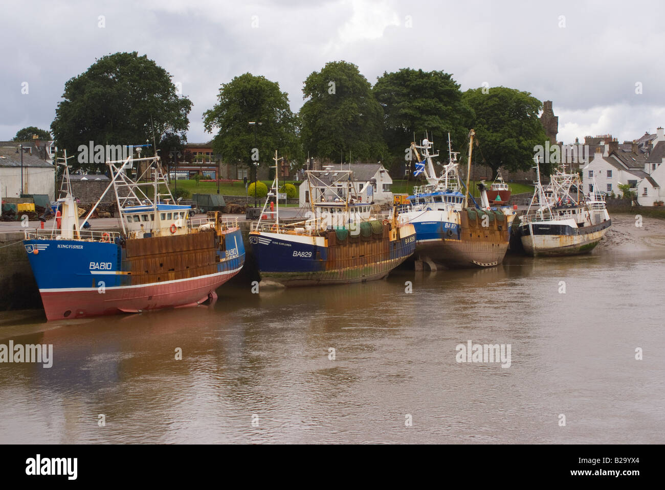 Fishing Boats Docked in Kirkudbright Harbour on River Dee with Tide Out Dumfries and Galloway Scotland United Kingdom UK Stock Photo