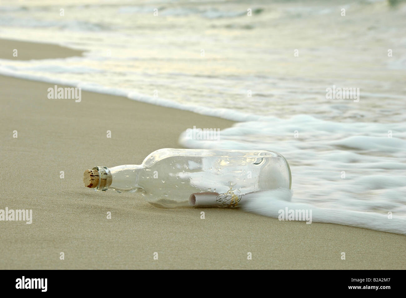 Message in a bottle being hit by the waves on a distant shore Stock