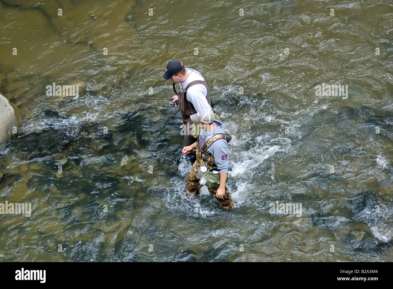 1940s 1950s SMILING WOMAN STANDING IN STREAM FLY FISHING WEARING VEST AND  WADERS Stock Photo - Alamy