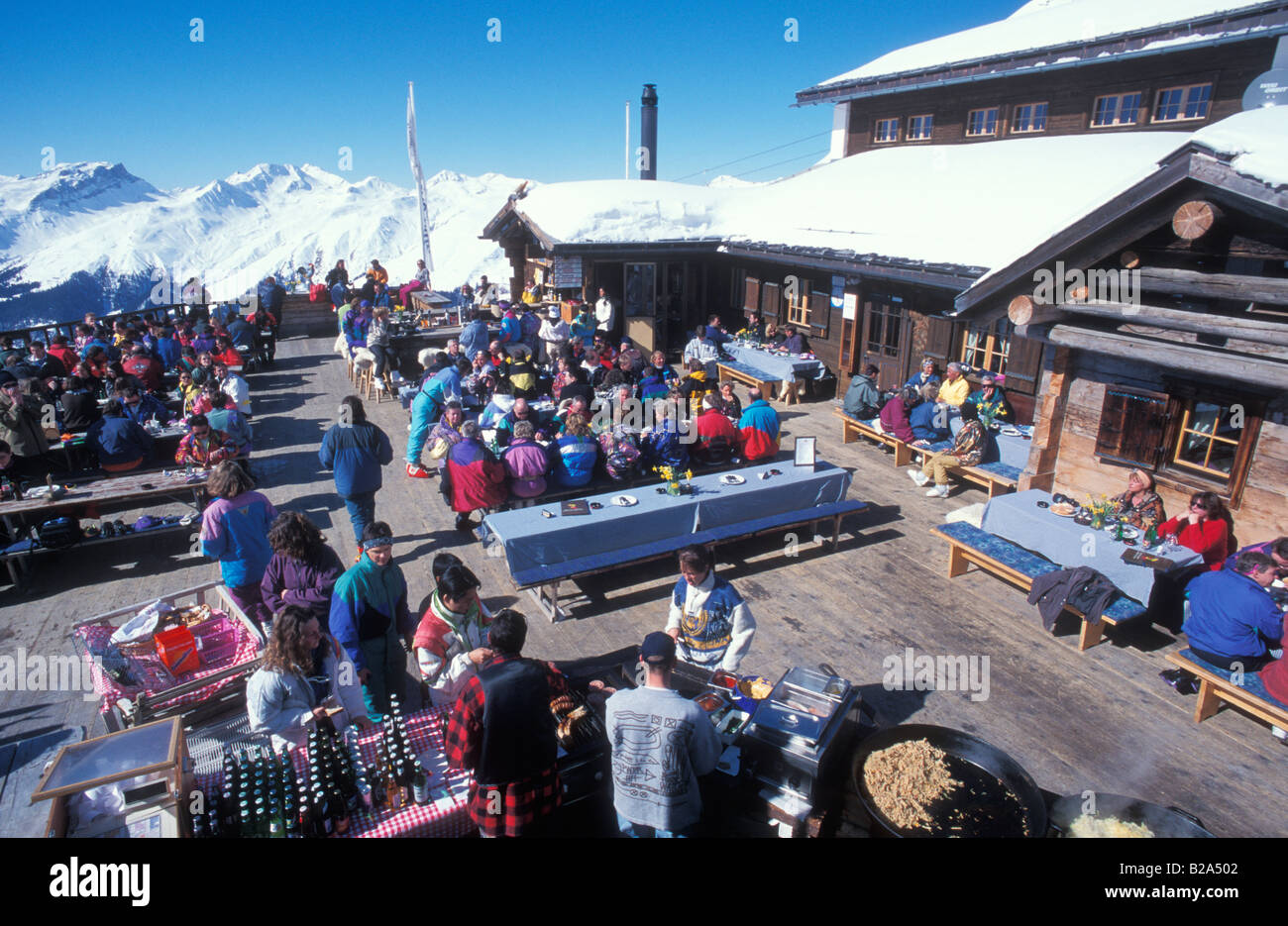People sitting on terrace of a ski hut at the Jacobshorn mountain near