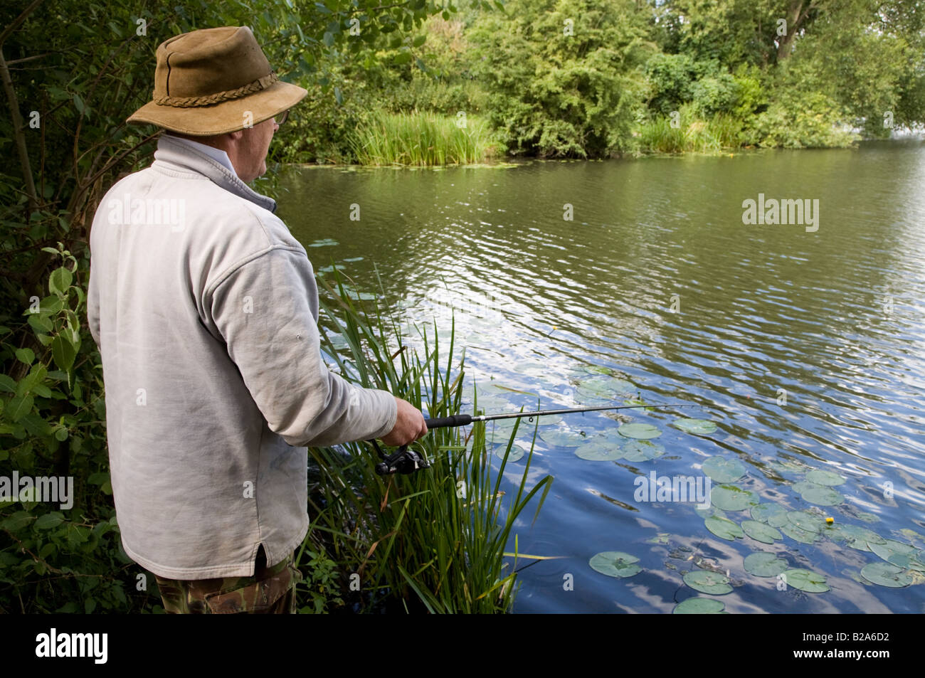 man fishing in Farlows lake Iver Bucks UK Stock Photo