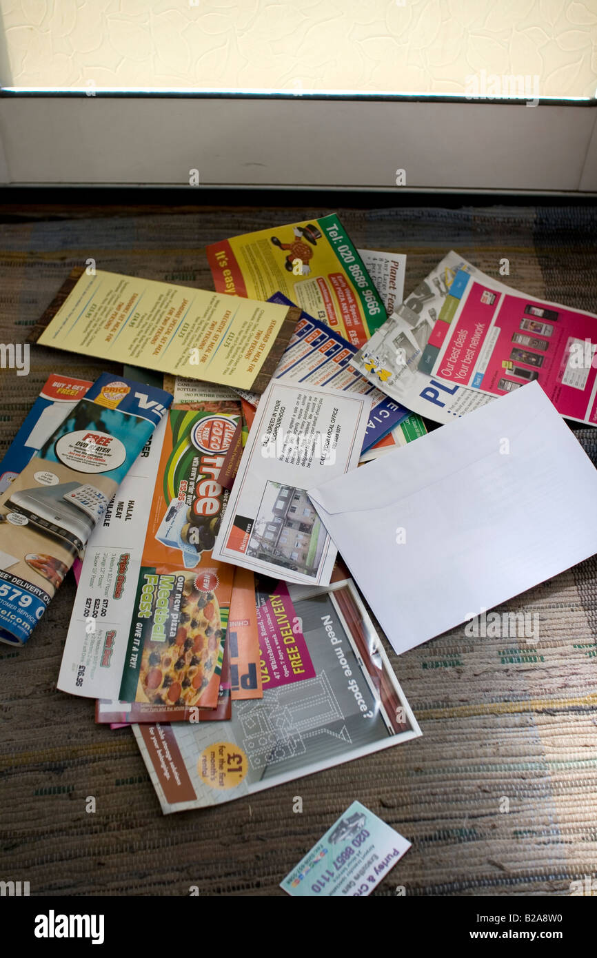 Junk mail on the doormat Stock Photo