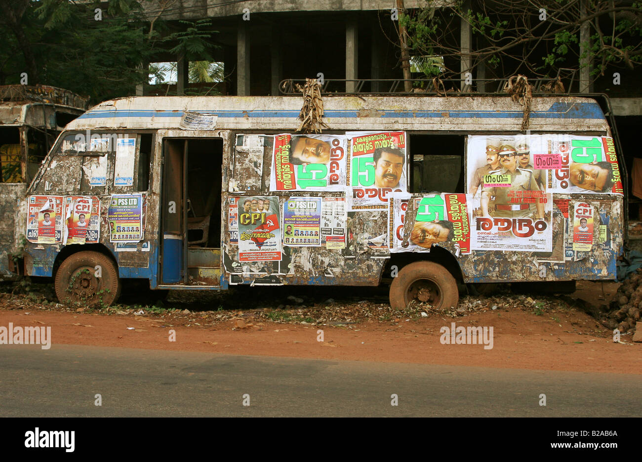 Abandoned bus used as a billboard Kerala India Stock Photo