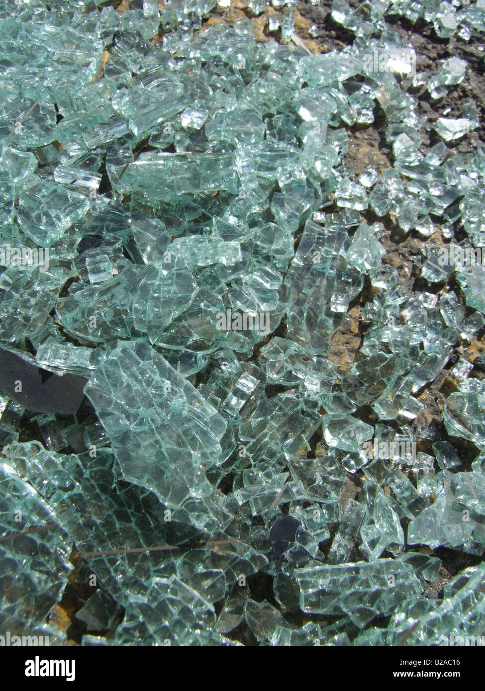 glass from smashed car window on road surface Stock Photo