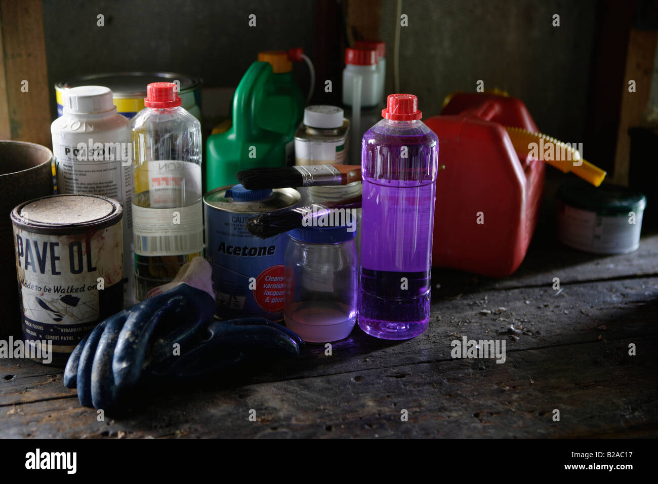 Poisonous household products in a garden shed Methylated spirits turpentine paint stripper petrol can gloves Stock Photo