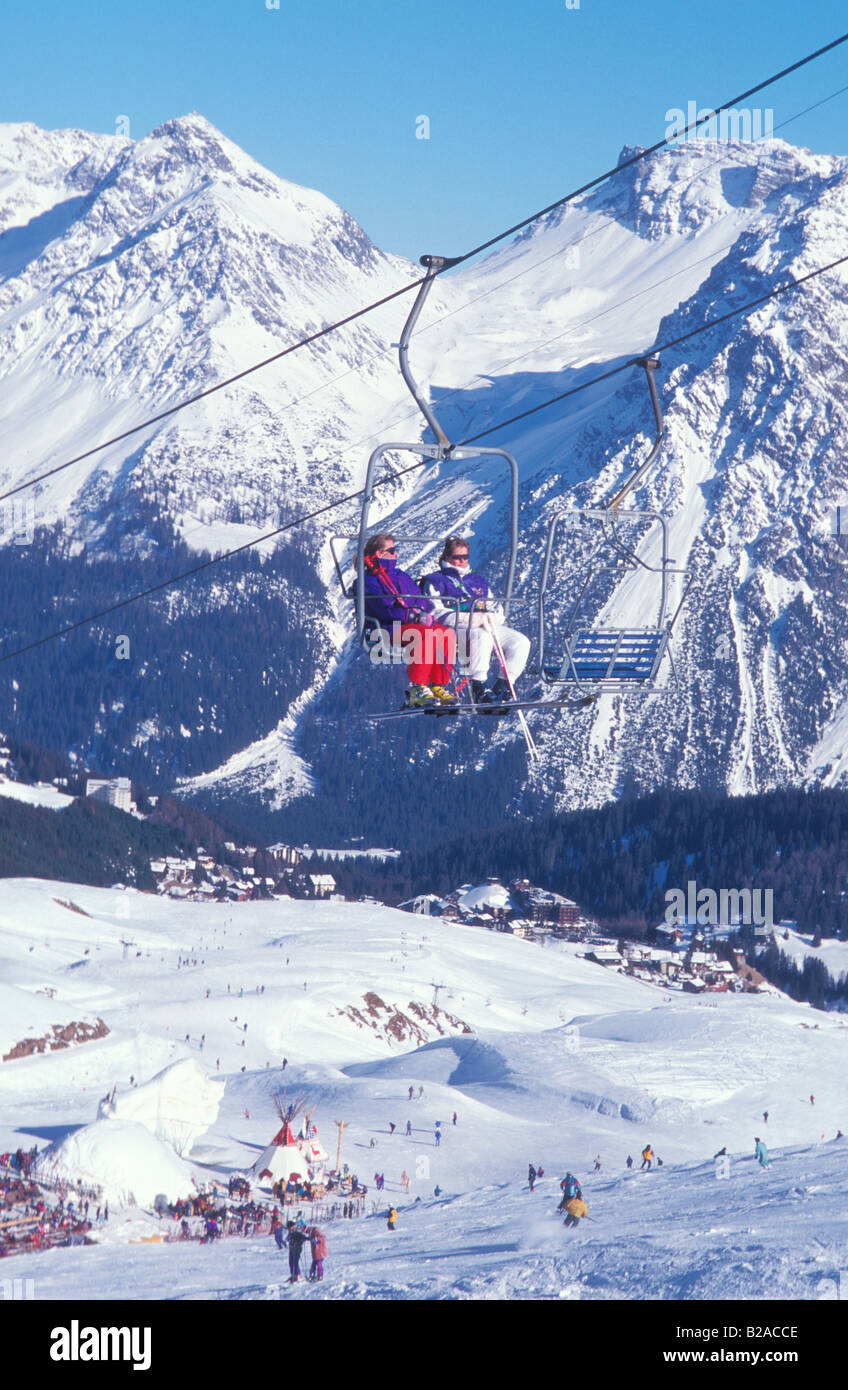 Skiers sitting in a skilift in Arosa Grisons Switzerland Stock Photo
