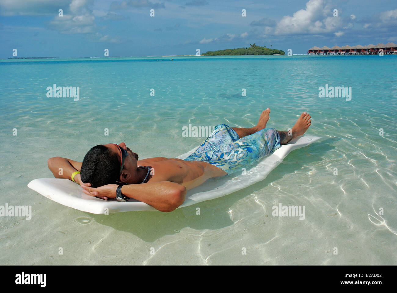 resting on vacation at paradise Maldives island resort Indian Ocean blue cristal clear sea water Stock Photo