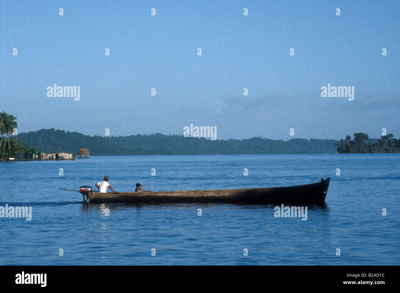 Man and boy in a motorized boat near the town of Bocas del Toro, Isla Colon, Panama Stock Photo