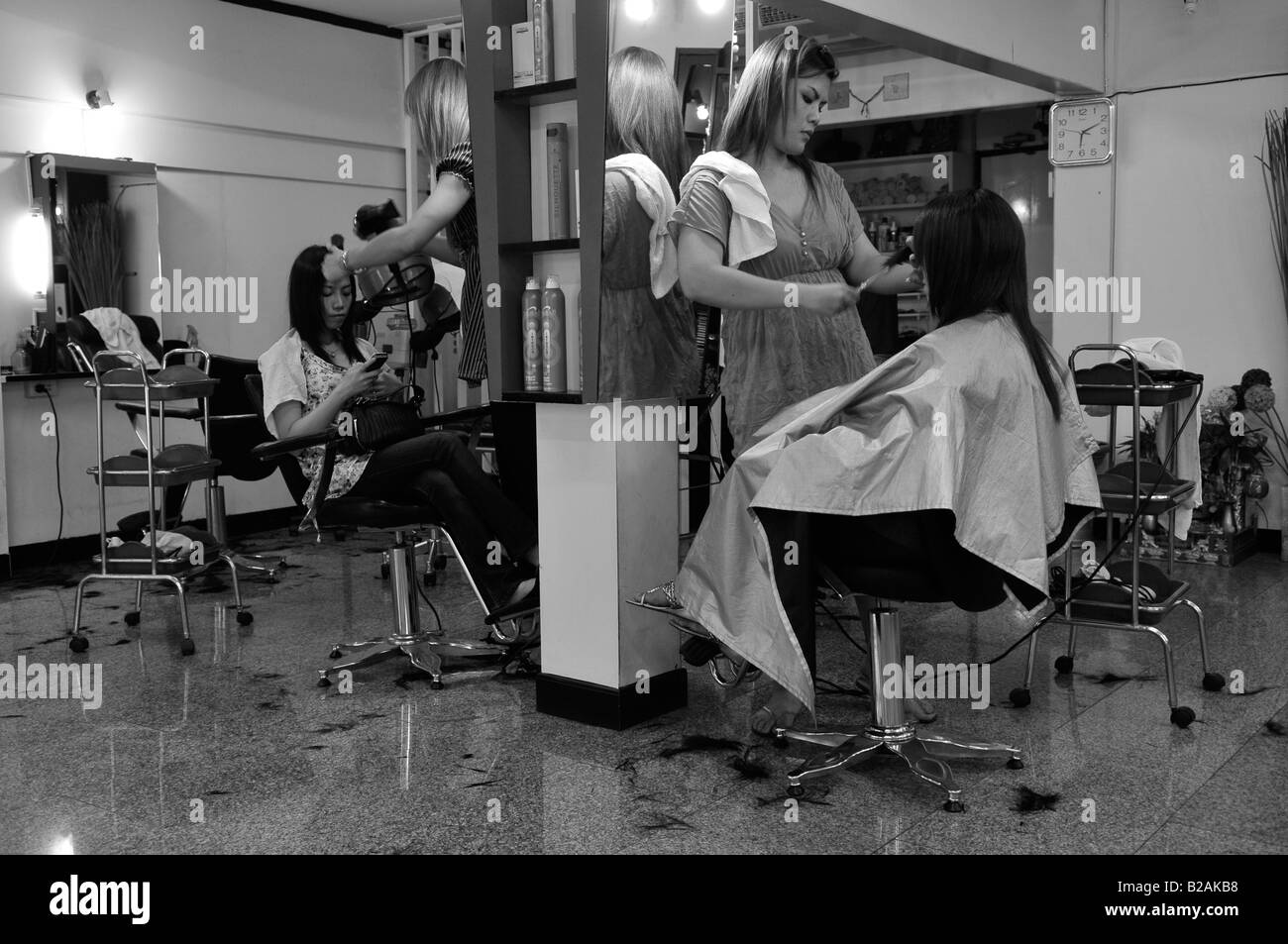 miss bangkok having a cut a blow dry by ladyboy hairdresser , bangkok, thailand Stock Photo