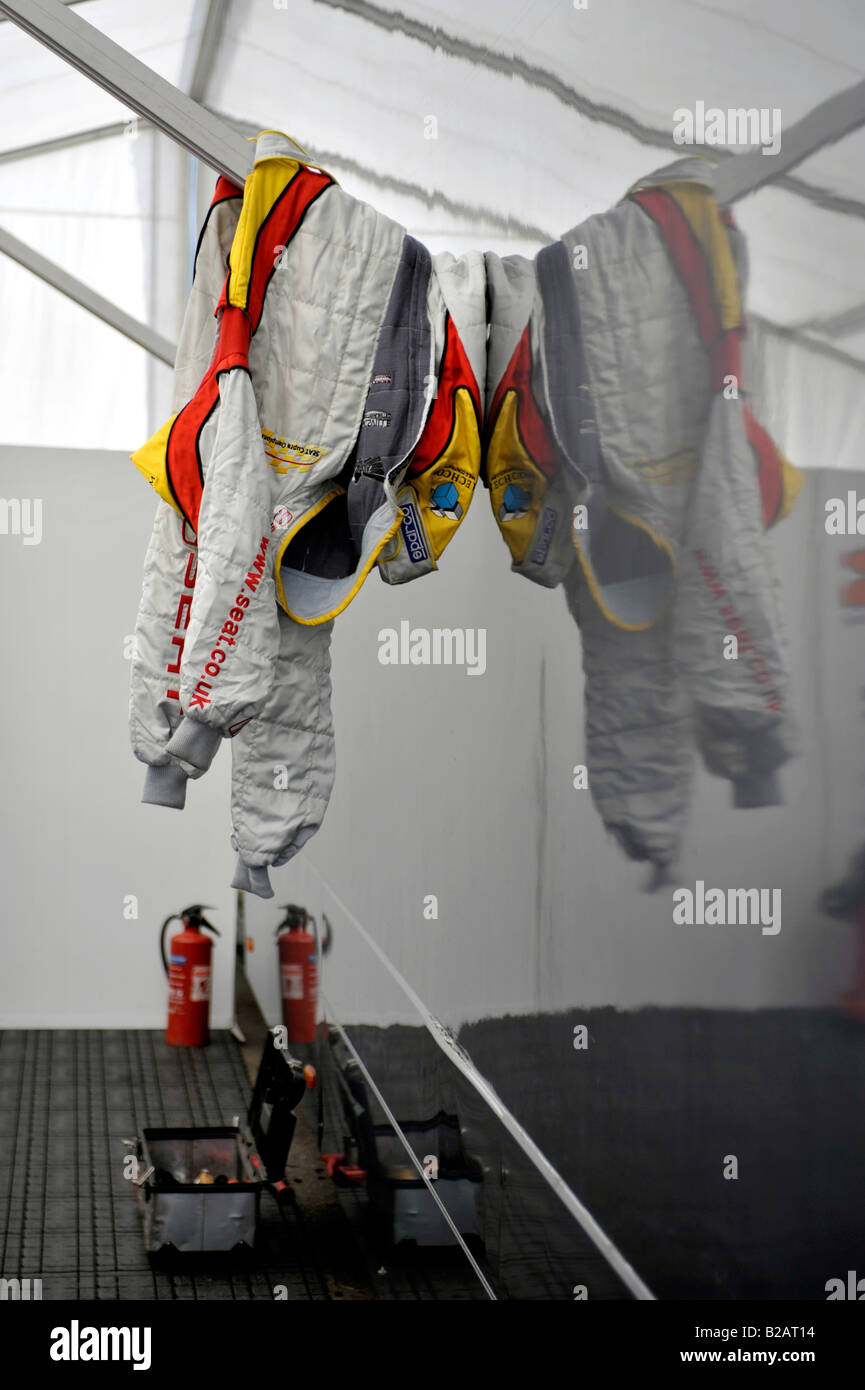 racing driver fire proof overalls hanging up in pit over fire ...