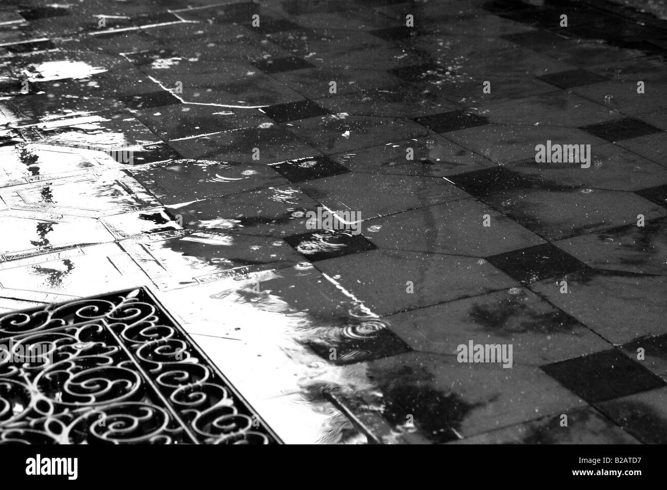 Detail of courtyard floor tiles on a rainy day Stock Photo
