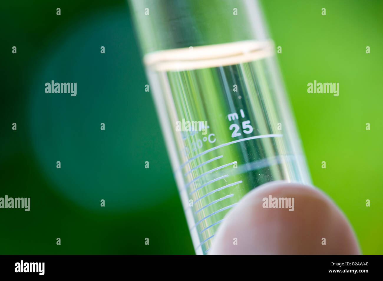 hand holding small test tube of clear liquid outdoors Stock Photo Alamy