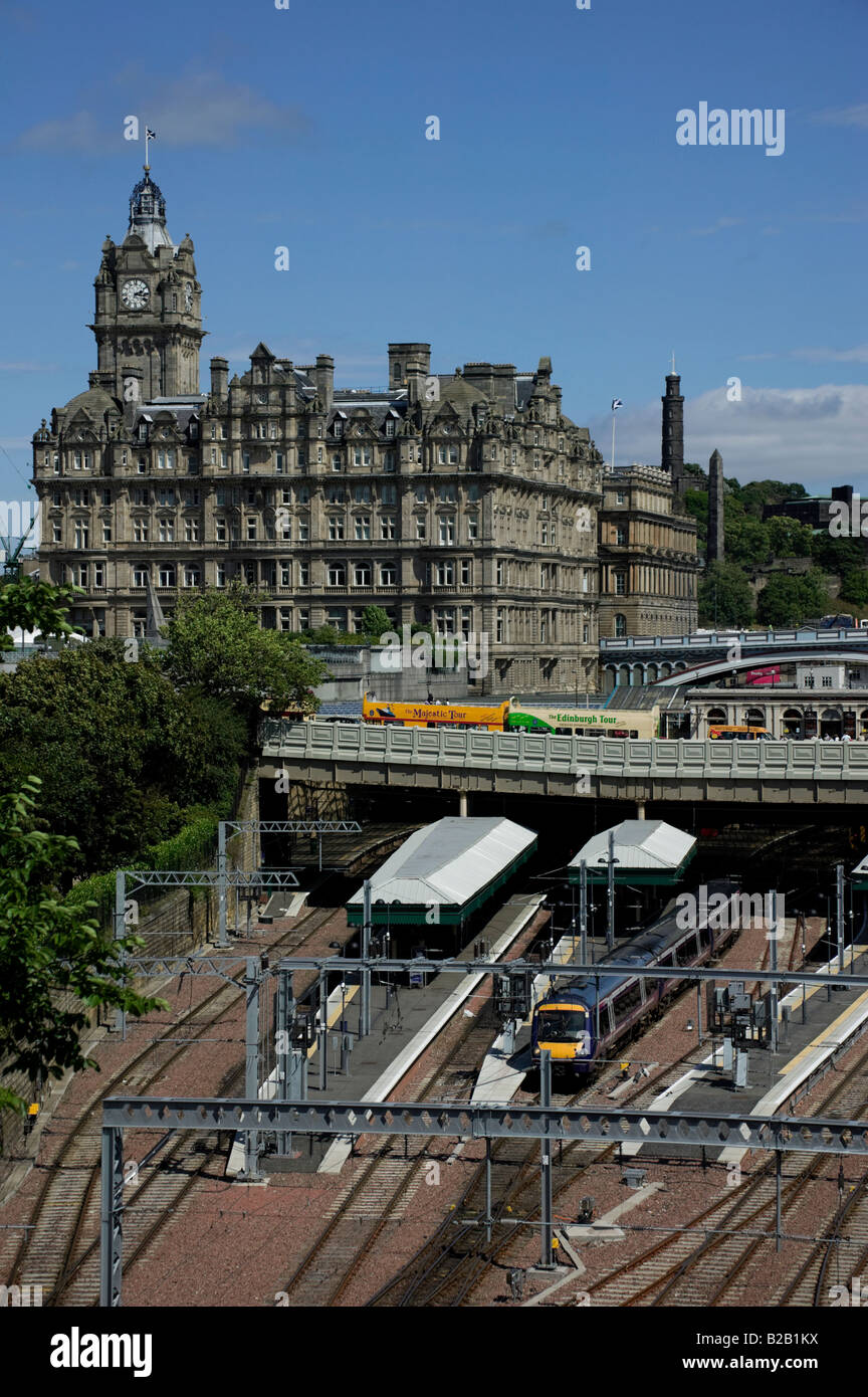 Train leaving Edinburgh's Waverley Station with Balmoral Hotel in background, Scotland, UK, Europe Stock Photo
