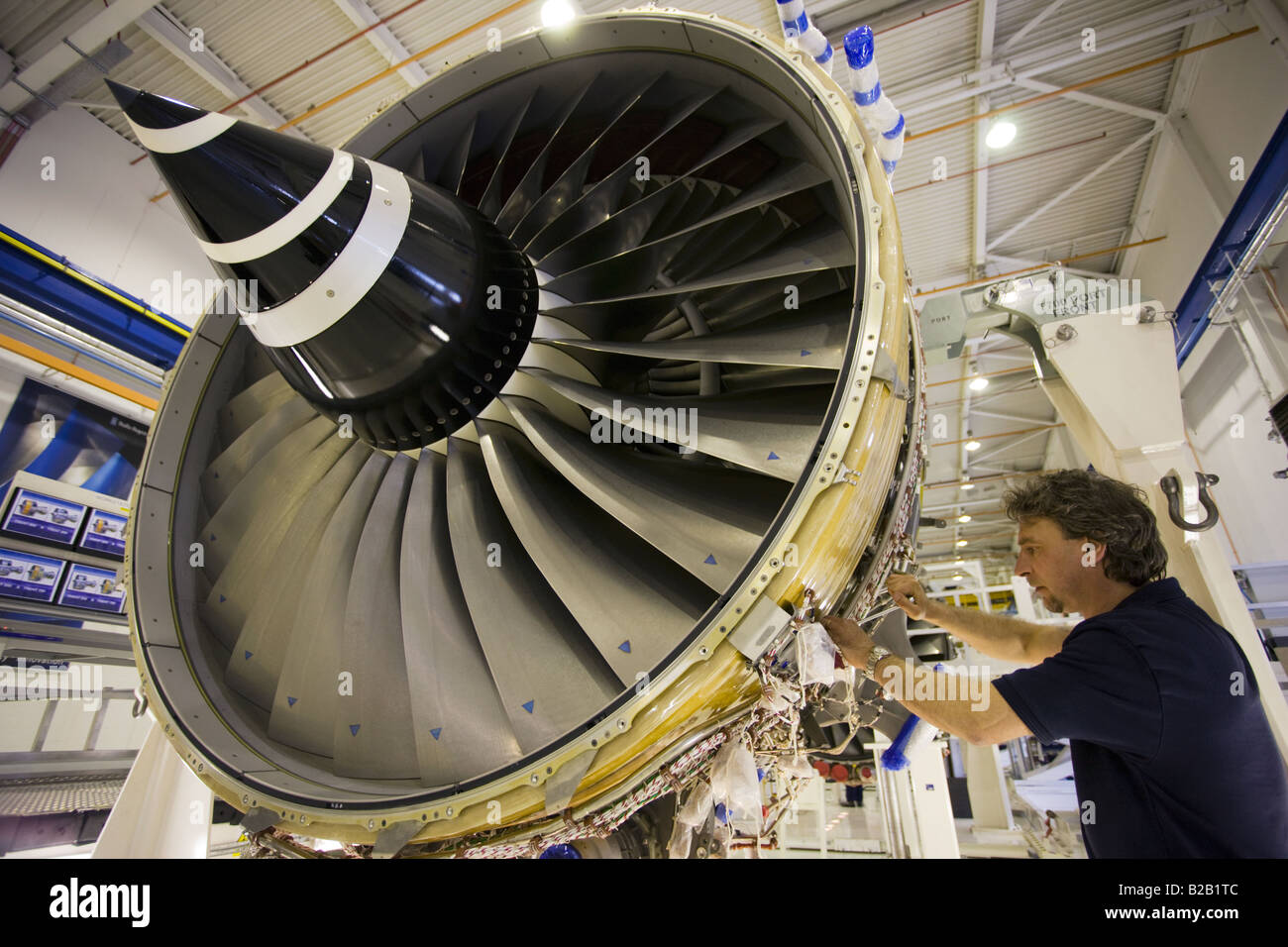 Engineer works on a Rolls Royce jet engine in the production factory Derbyshire United Kingdom Stock Photo