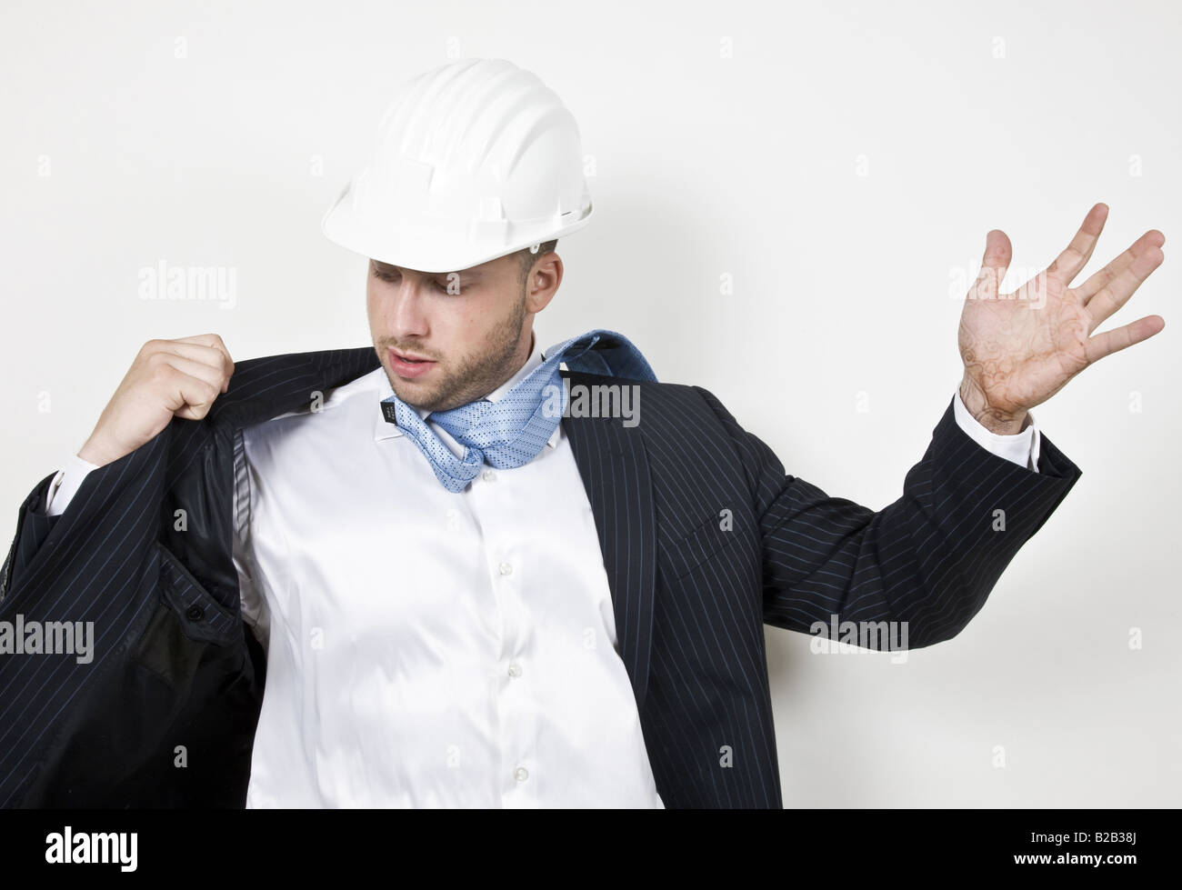 man adjusting his coat with open palm Stock Photo