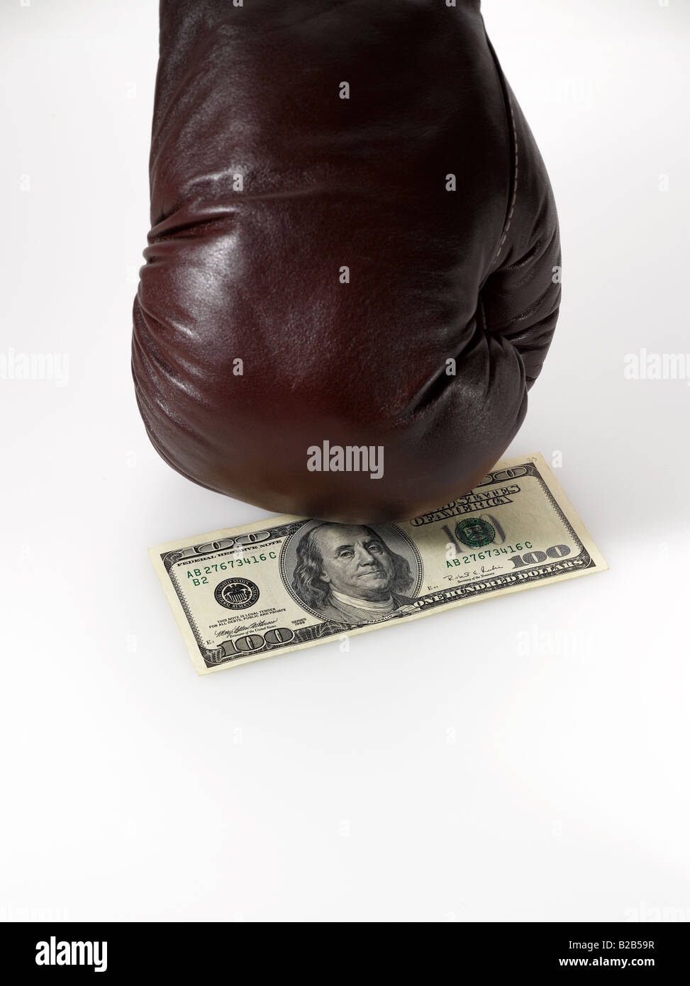 boxing glove punching American dollar bill on white background Stock