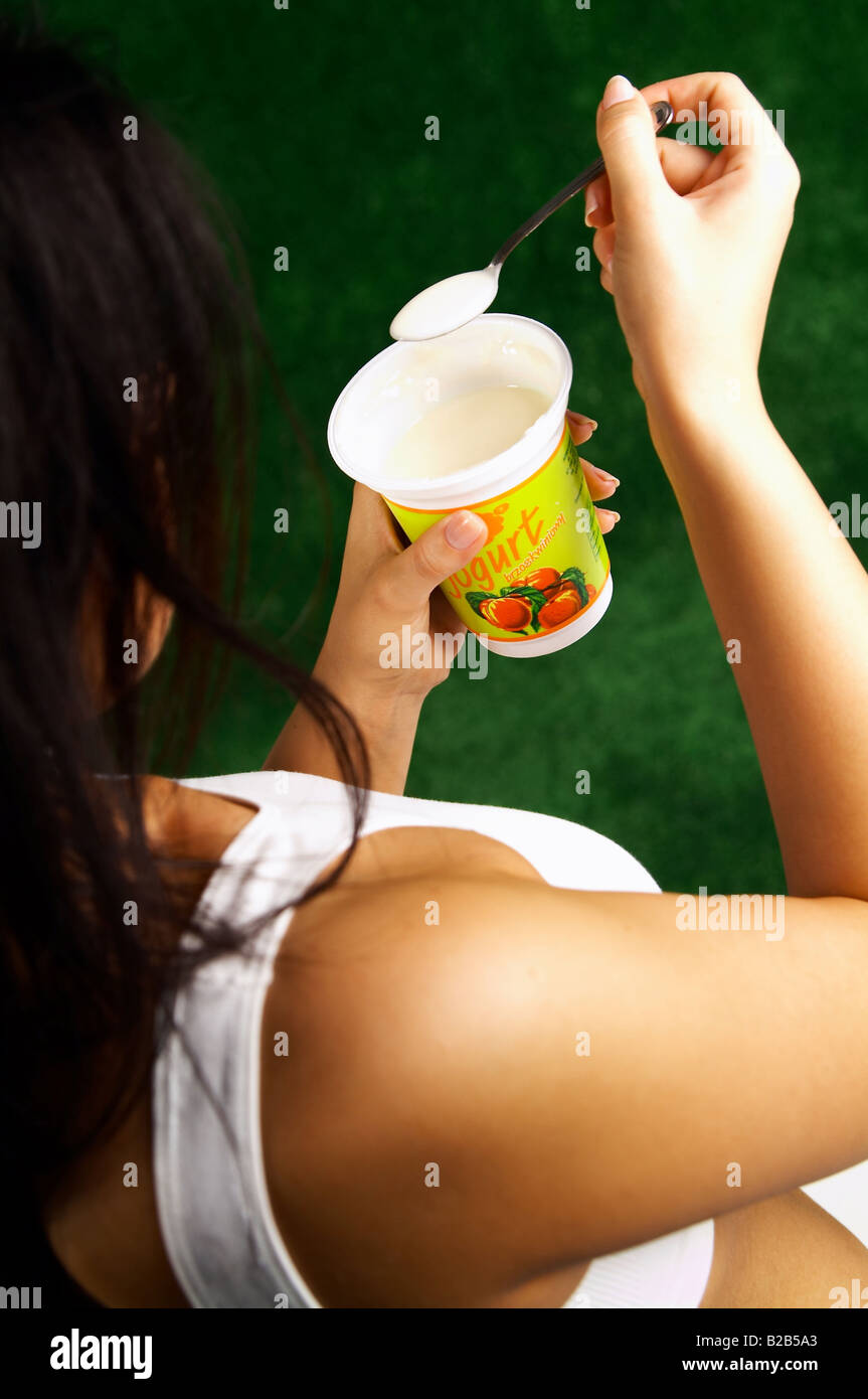 Woman Eating Yogurt Stock Photo Alamy