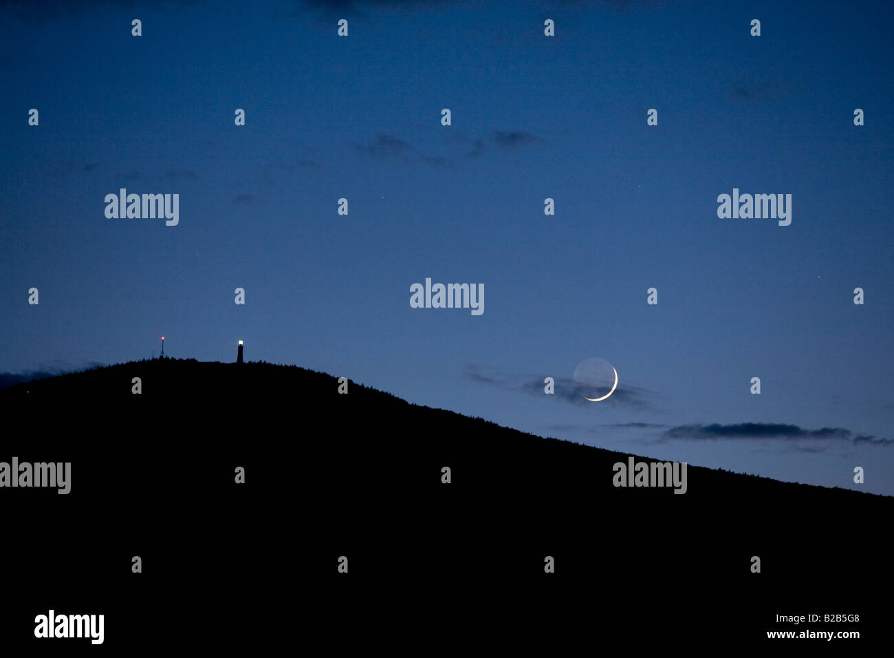 The moon is setting over Mount Greylock in Adams Massachusetts Stock Photo