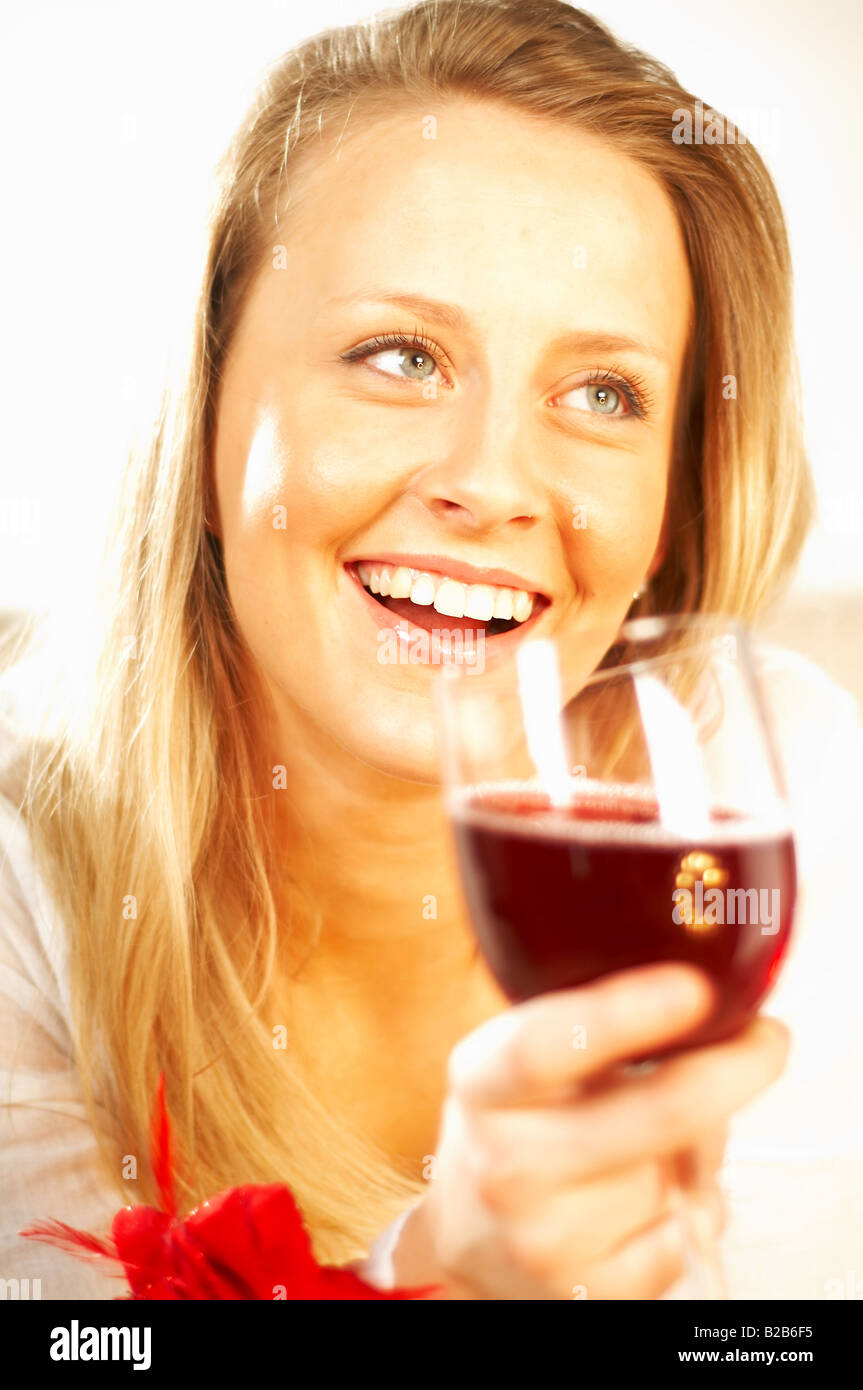 Pretty young blonde women with glass of red wine Stock Photo - Alamy