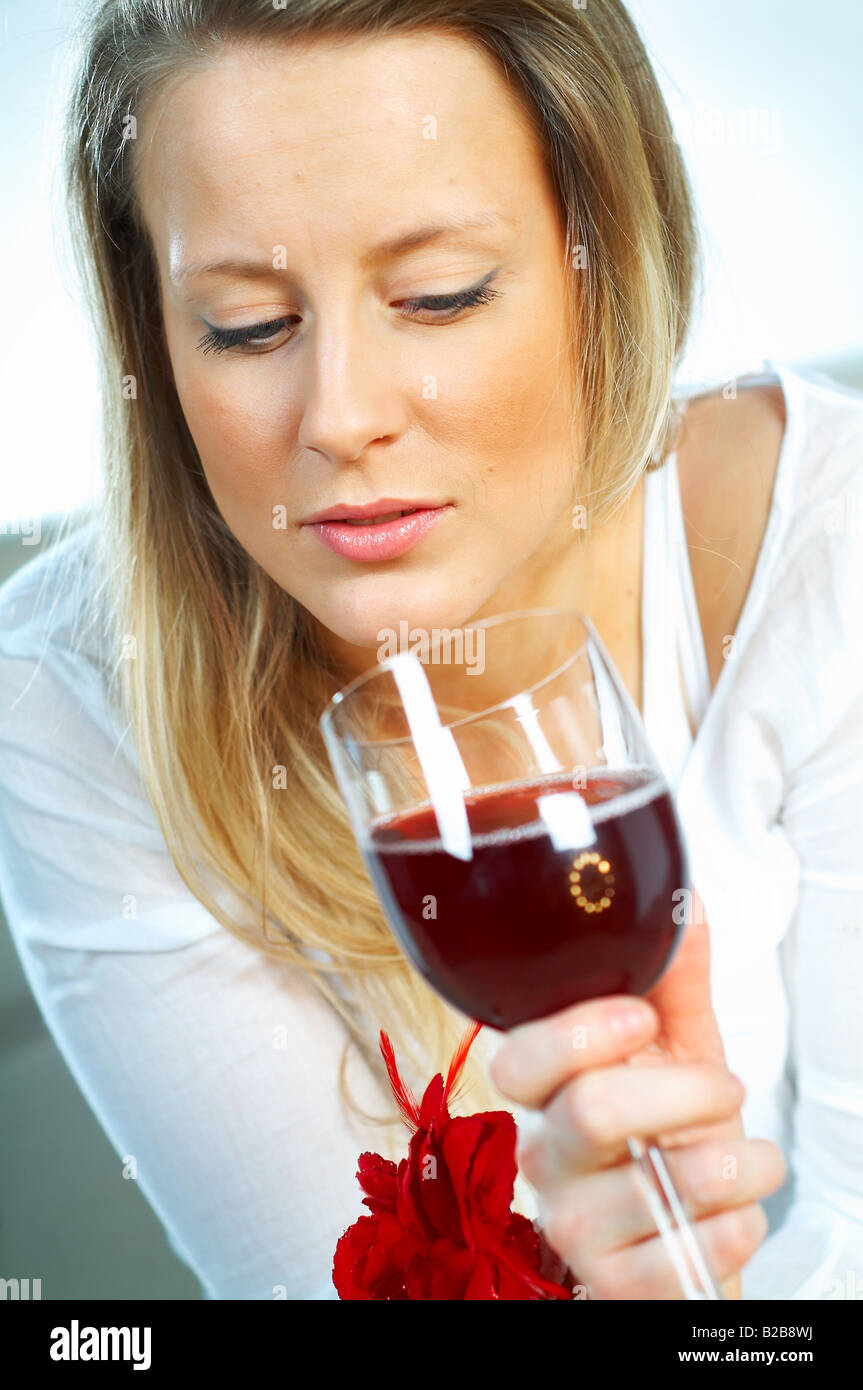 Pretty young blonde women with glass of red wine Stock Photo - Alamy