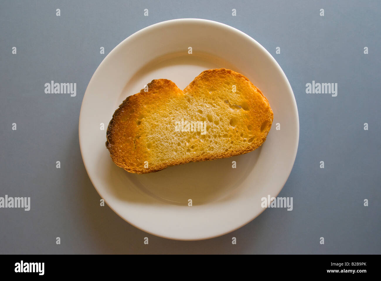 Slice of dry toast on a white plate Stock Photo Alamy