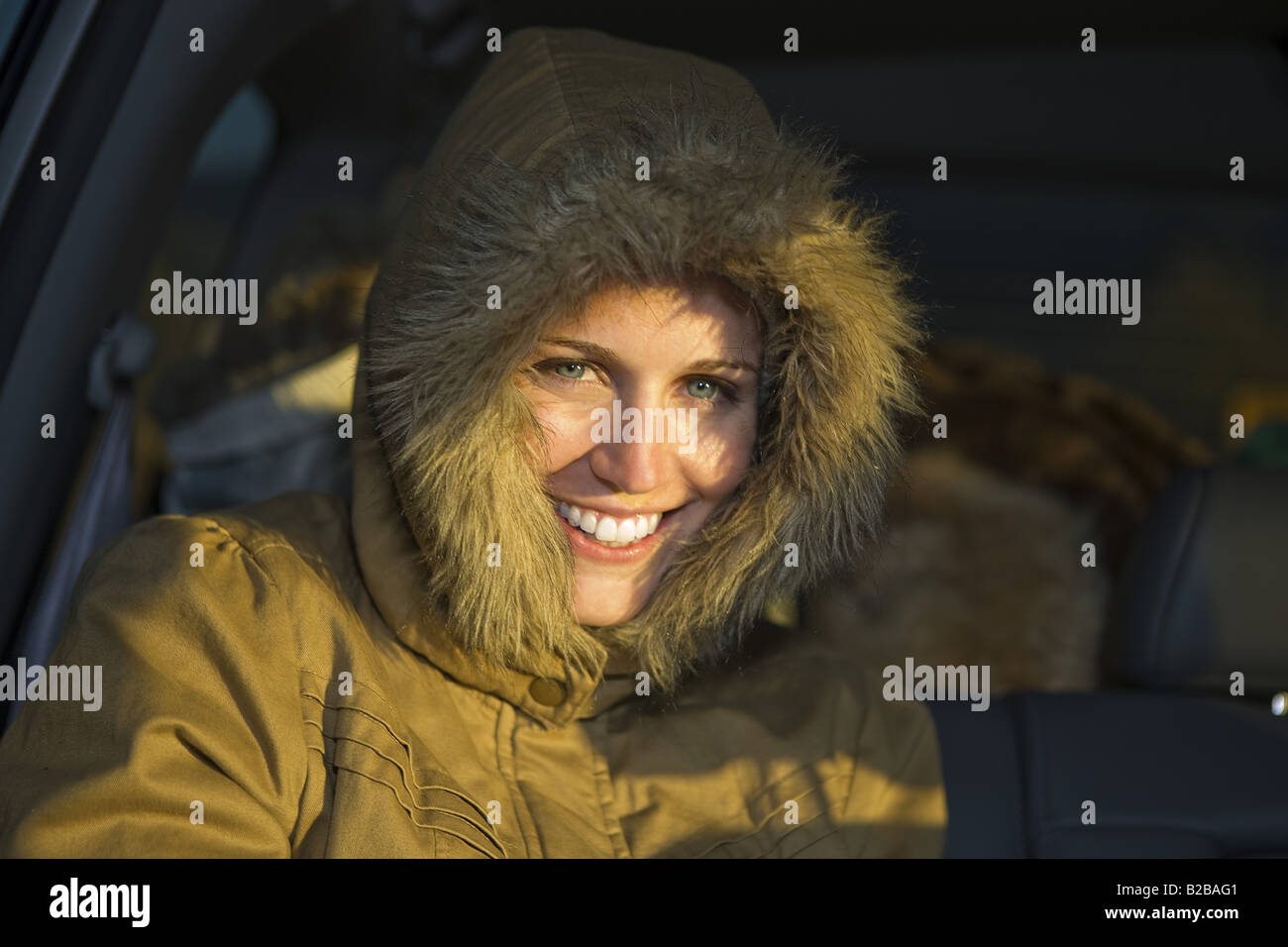 Young woman in fur trim ski jacket Stock Photo