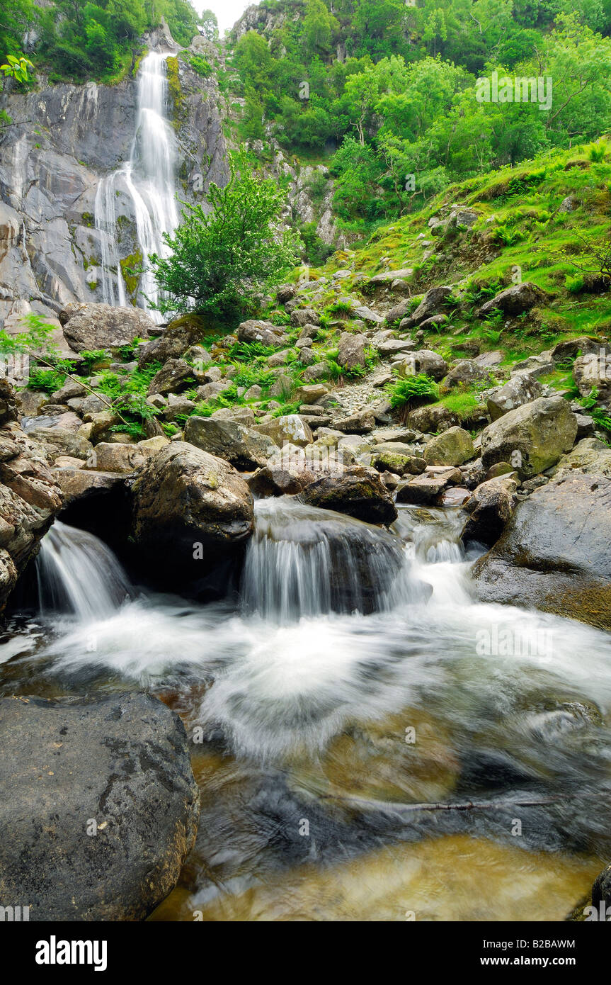 Afon Rhaeadr Fawr Near Bangor in North Wales flowing through Coedydd Aber with Aber Falls in the background Stock Photo